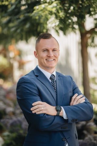 Michael Kissinger, founder of Localkept, smiling, in a blue suit outdoors